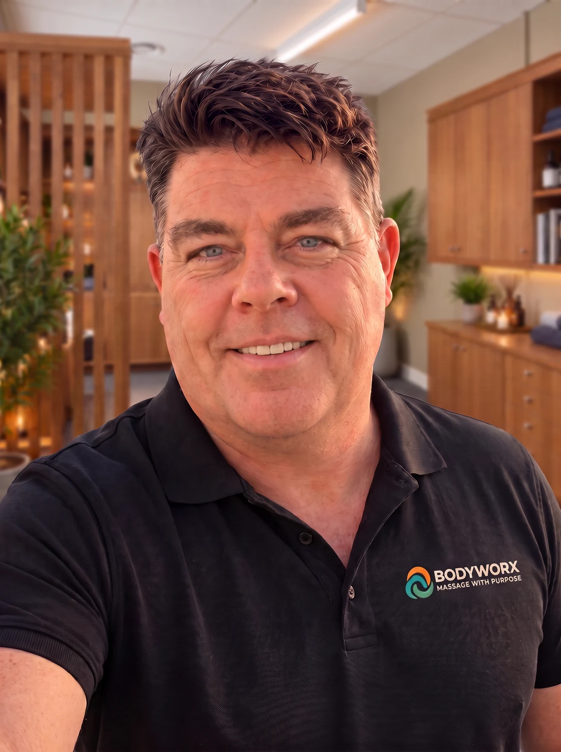 Mike Ellings smiling in a black branded polo